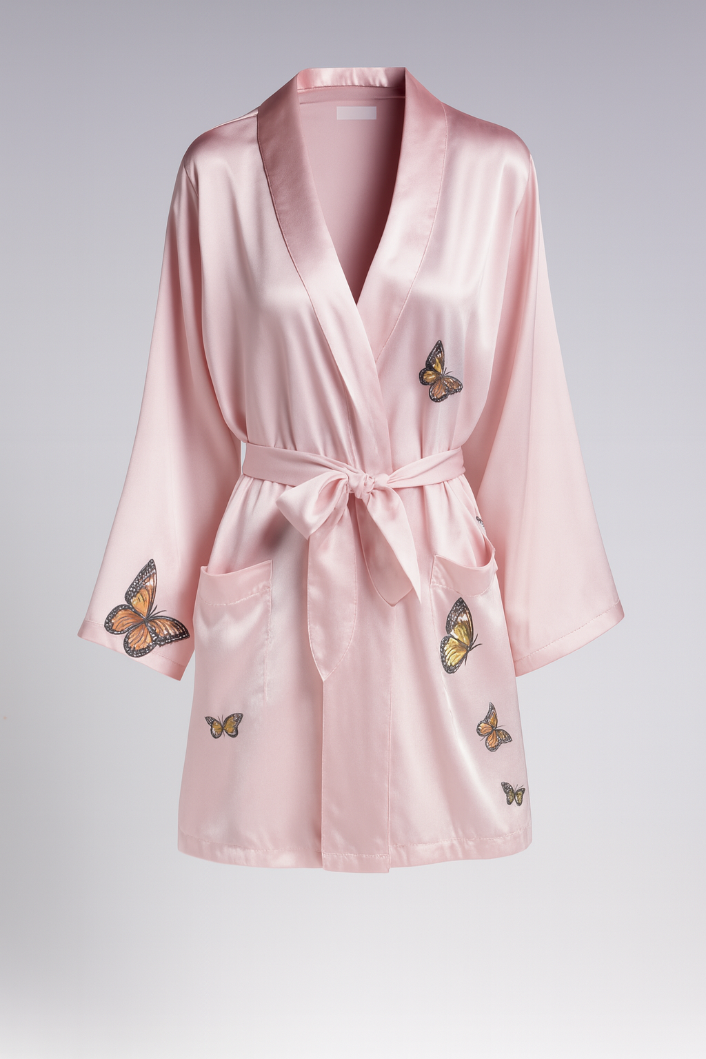 Zariah — Short blush satin robe with butterfly motifs, wide kimono sleeves, and patch pockets.